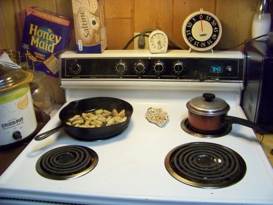 Mom's electric stove. Croutons are being cooked in a pan.